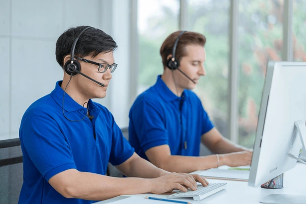 Photo of a call center team or dispatchers wearing headsets.